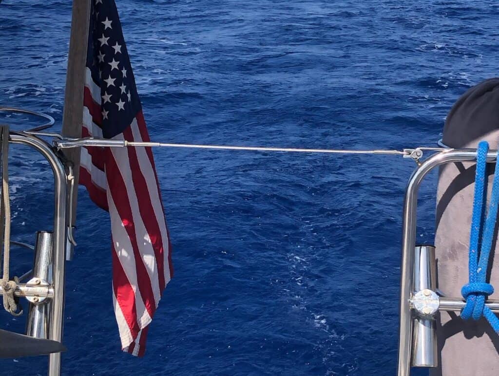 Photo taken from the stern of Pelagia as we are crossing the Gulf Stream. The water is deep, clear blue and you can see our American Flag flying off the stern.