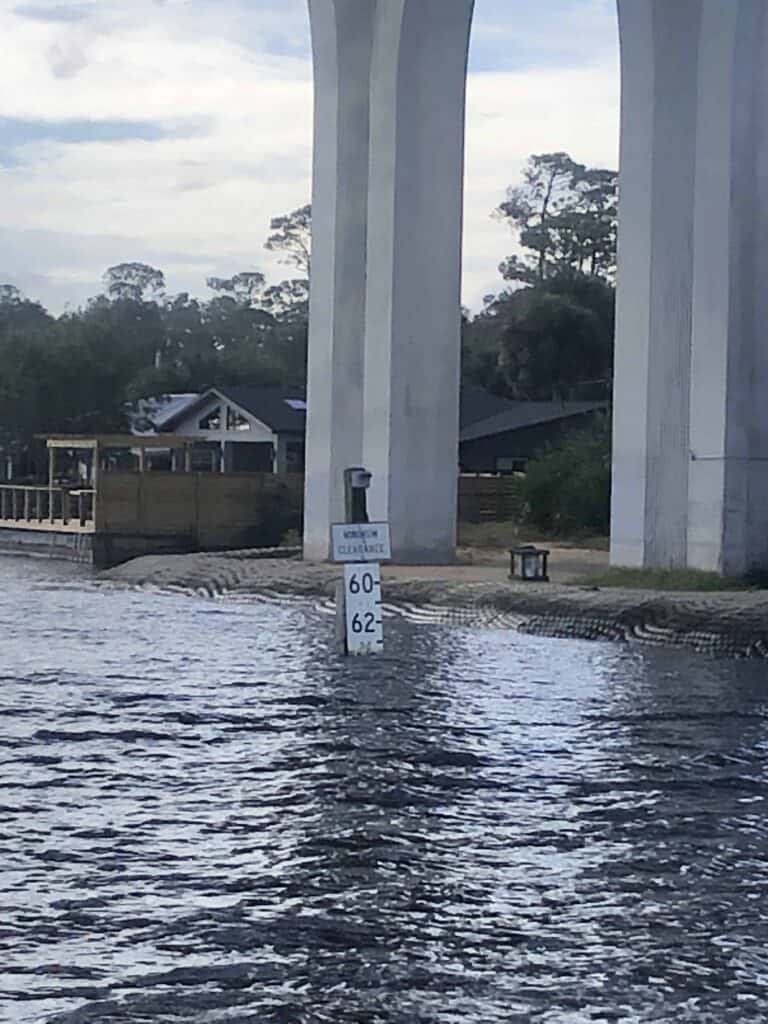 SR-100 bridge clearance sign that shows approximately 63.5 feet minimum clearance under the bridge.