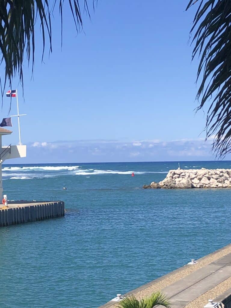 Waves crashing along a shoal at the entrance into Ocean World Marina on a sunny and otherwise calm day.