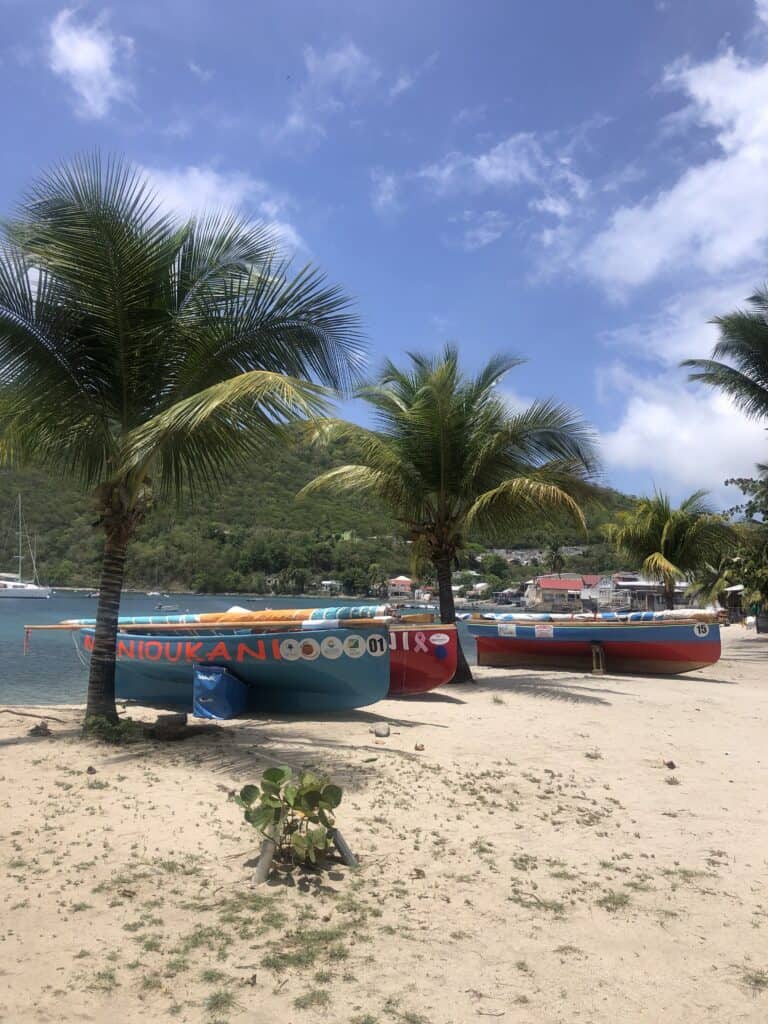Colorful boats sitting on the beach in Deshaies as we are sailing in the Leeward Islands