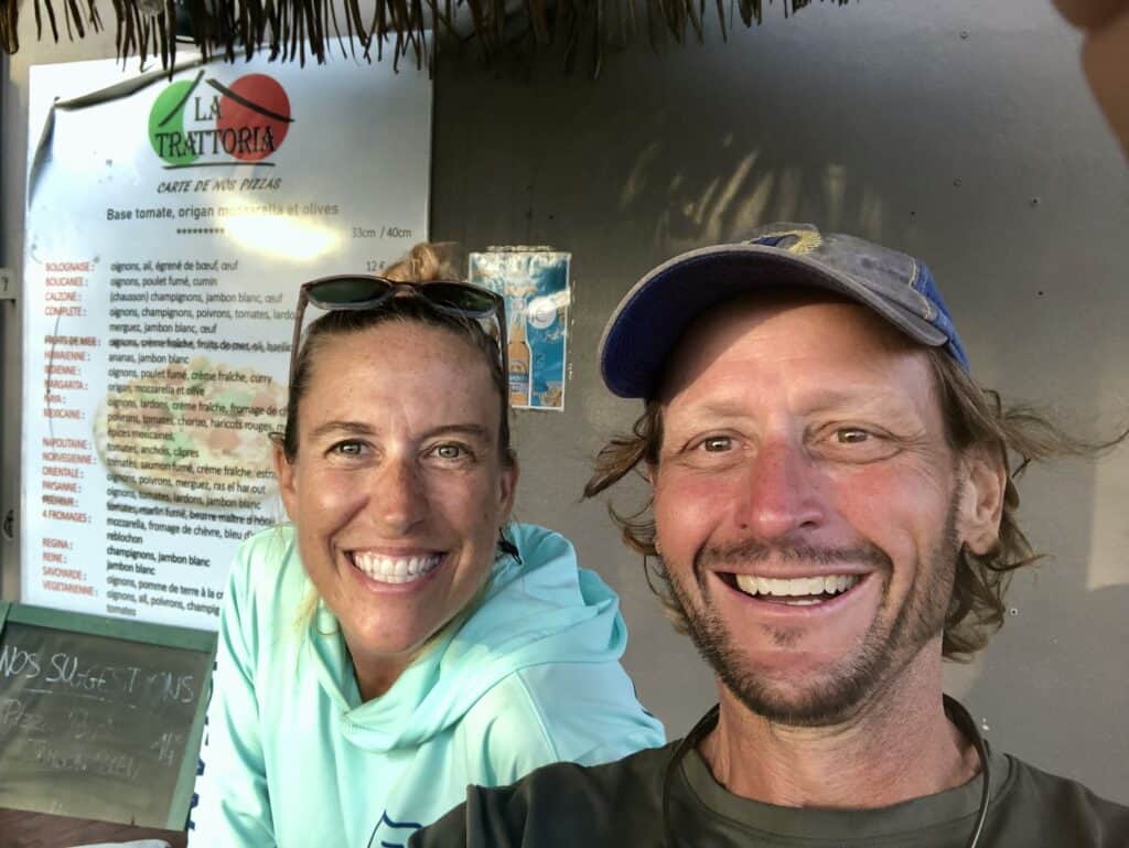 Scott and me with the Pizza Menu on the wall behind us in Malendure