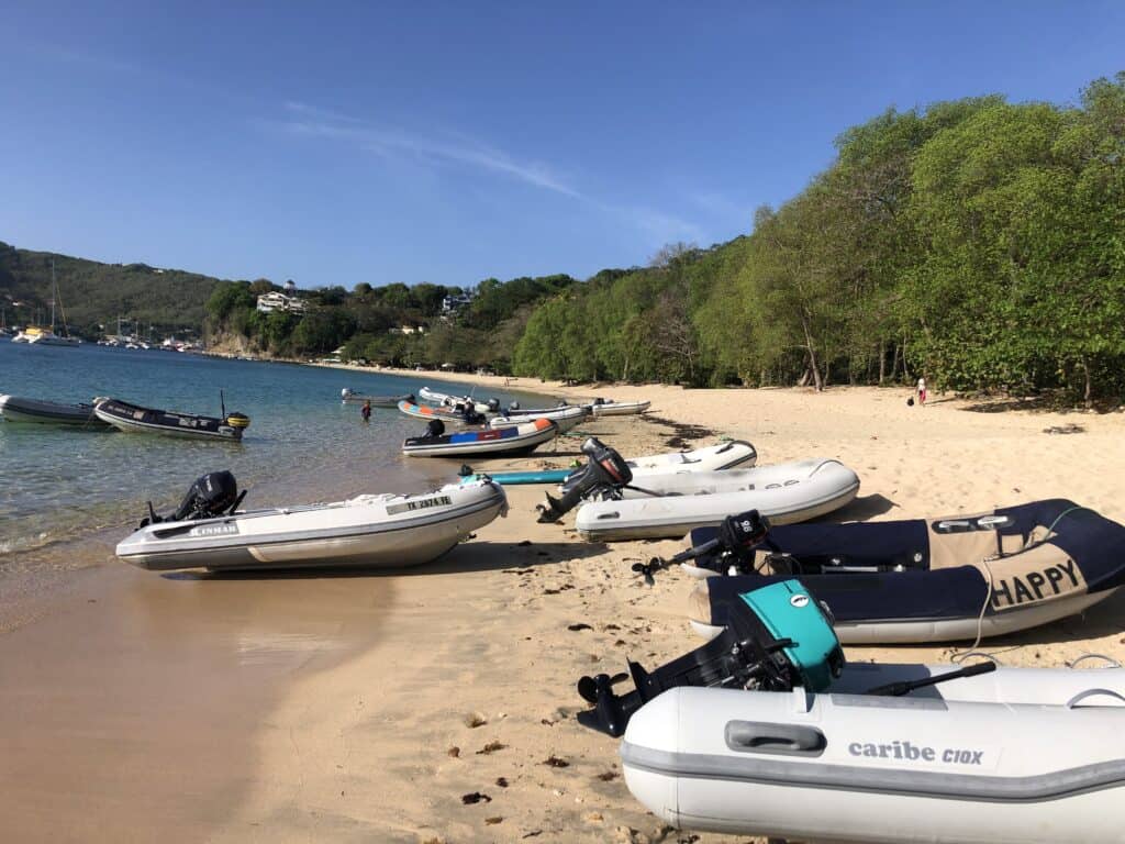 Dinghies gather on Princess Margaret Beach for an afternoon of fun things to do in Bequia.