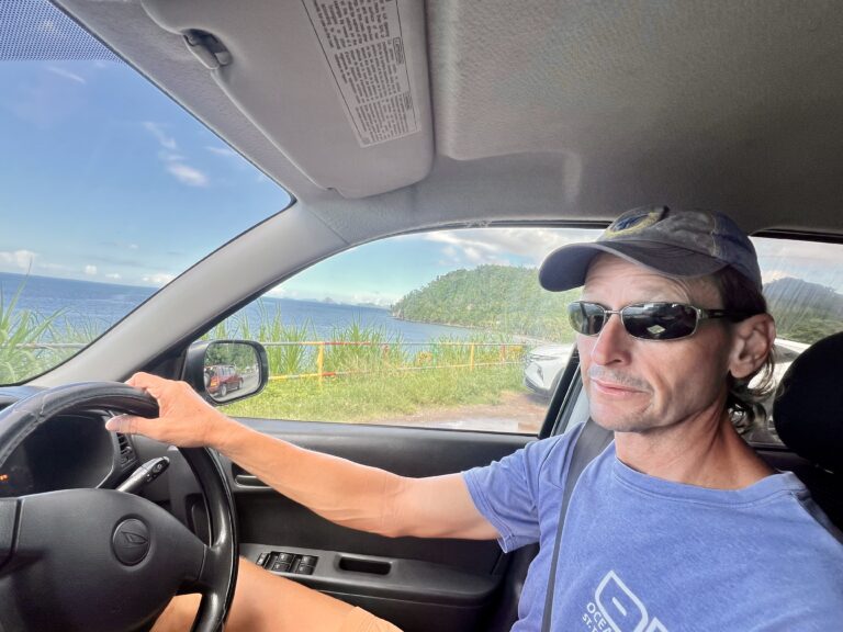 Scott in the drivers seat on the right side of the car used to get around in Grenada