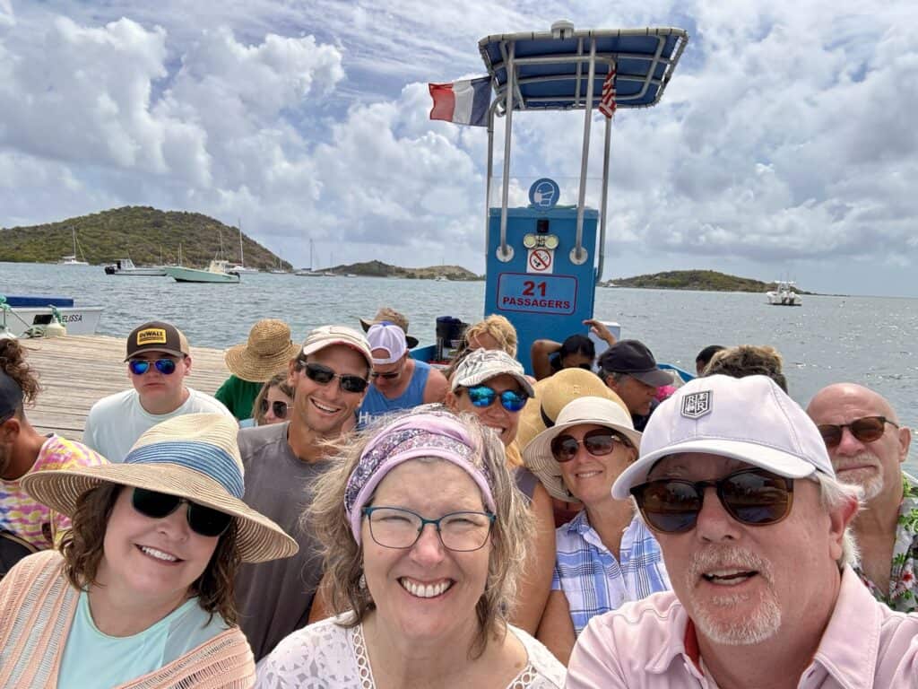 Scott, me and our friends pose for a selfie all aboard the Pinel Island Ferry that is very full of people and sitting at the dock ready to take us across the bay to Pinel Island. Ferries are one way to get around in St. Martin.